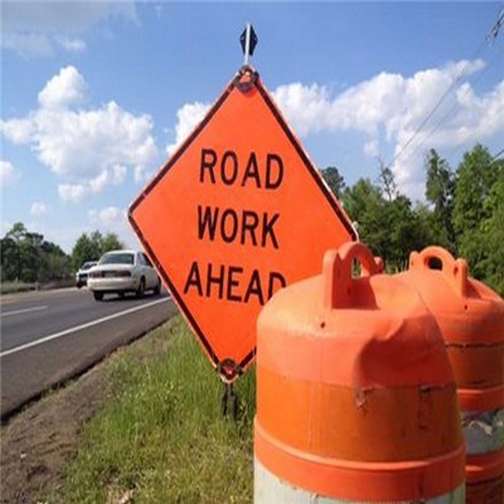 road work sign near a road