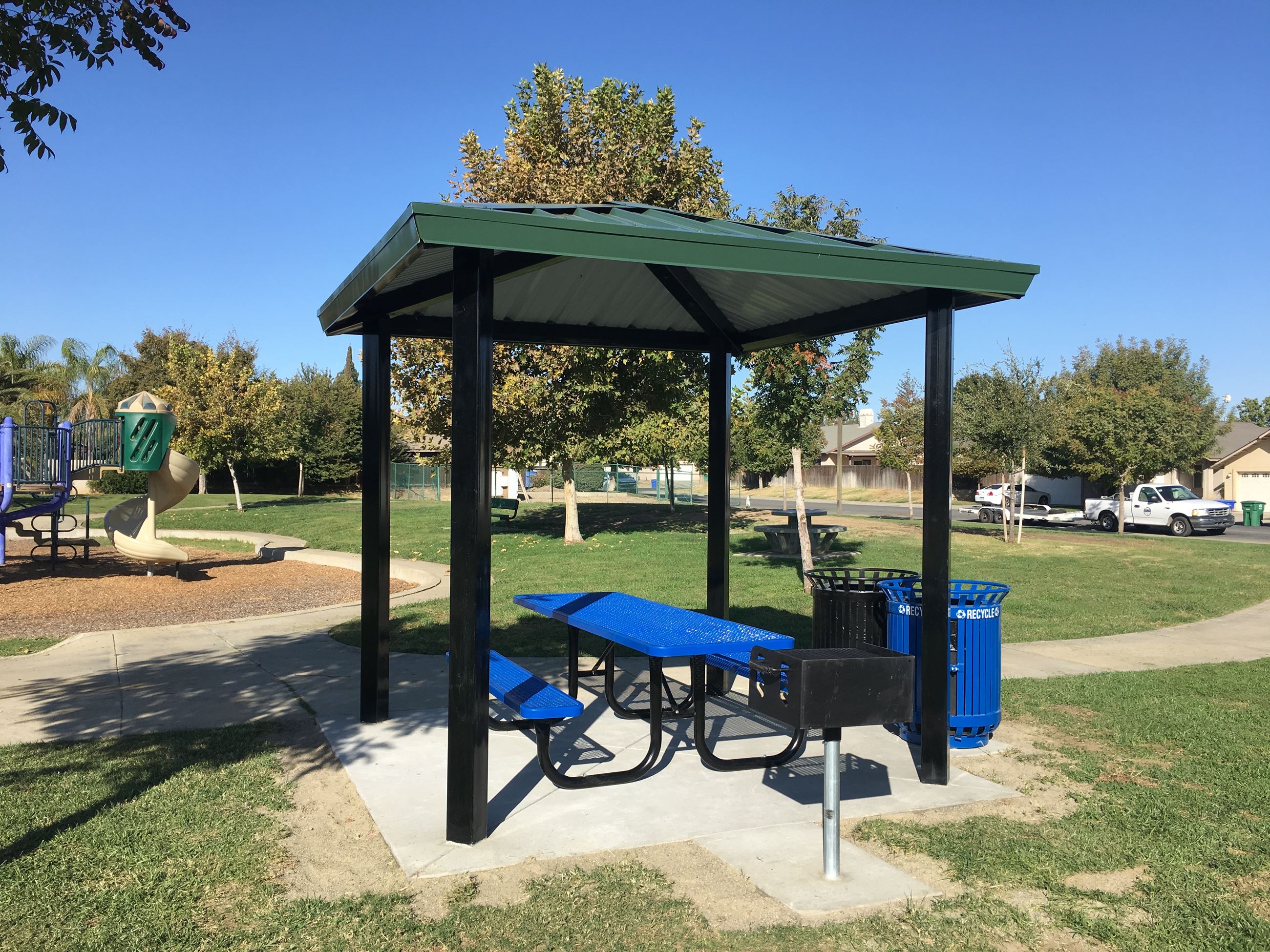 Sandalwood Park Awning  shade structure with 8ft table,bbq pit, and trash cans.
